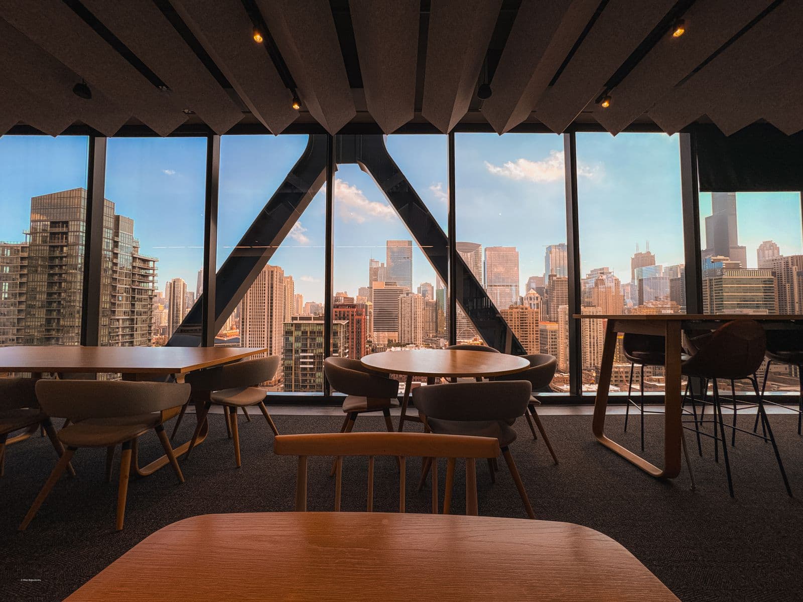 A modern office interior with panoramic windows overlooking a city skyline