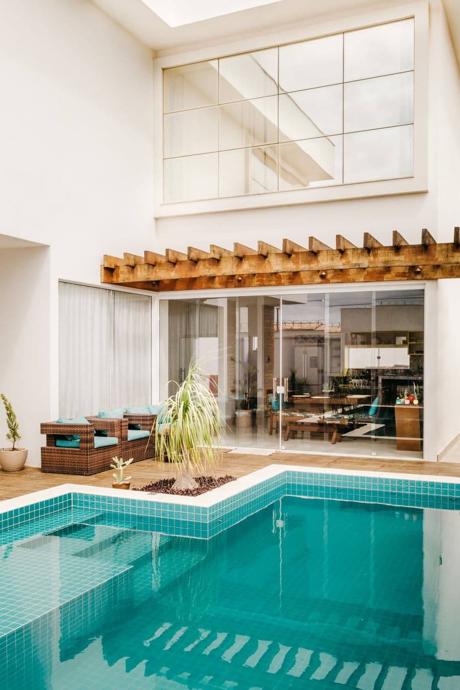 A resort building with a swimming pool and timber pergola