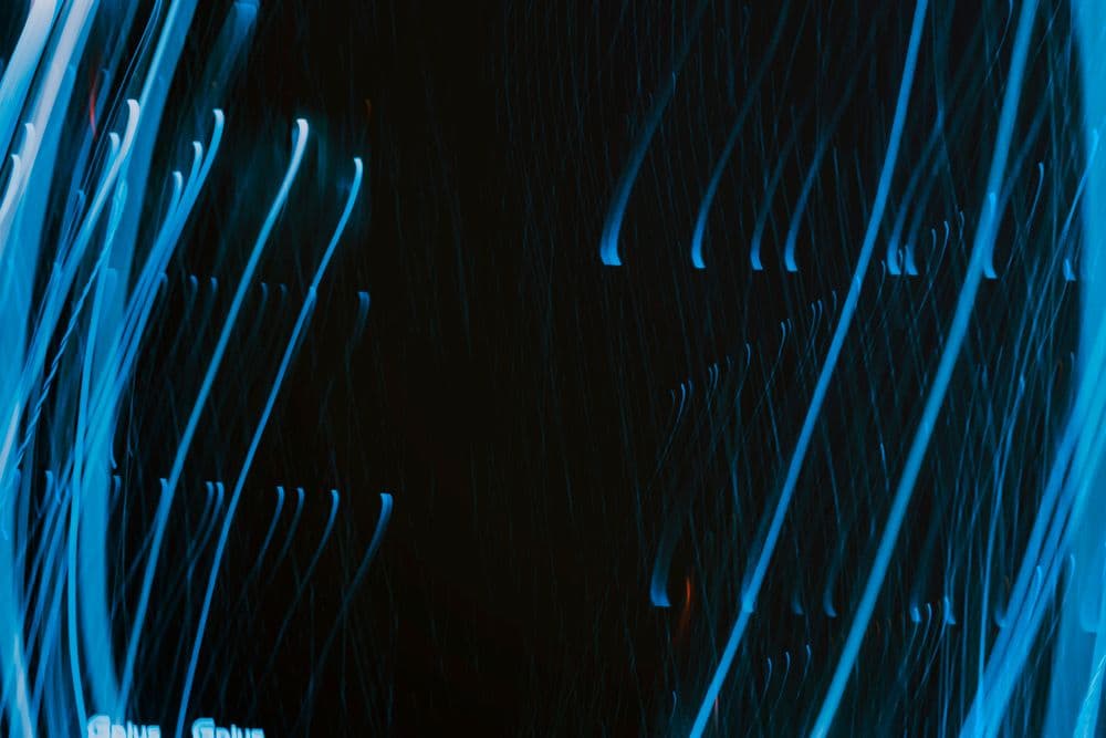 Streaks of blue light on a dark background